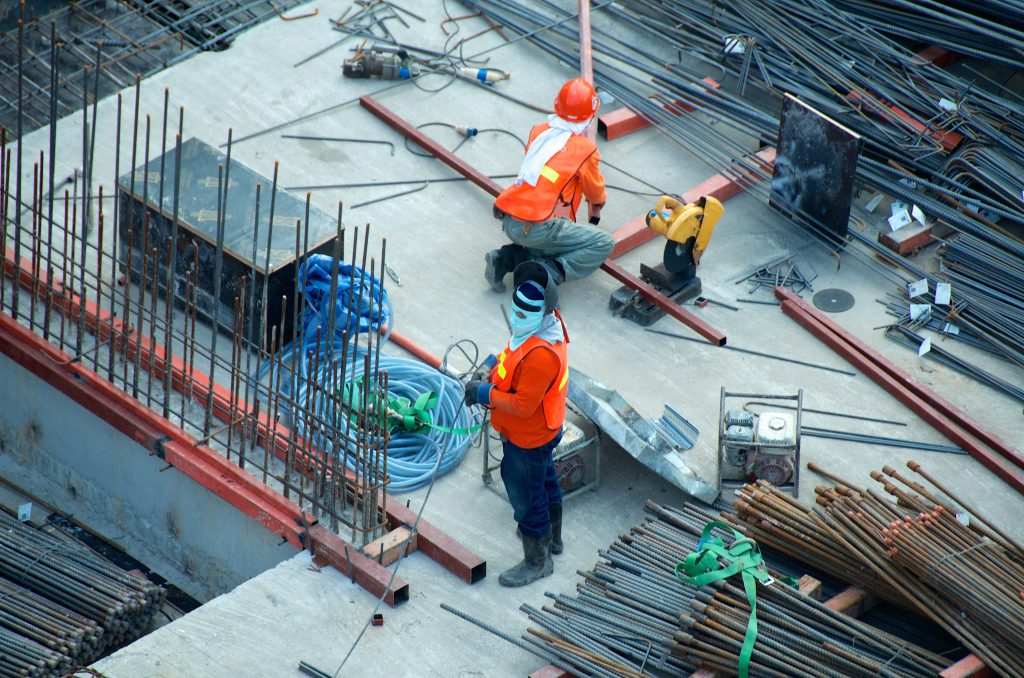 Two men working on a construction site representing the construction industry in Libya